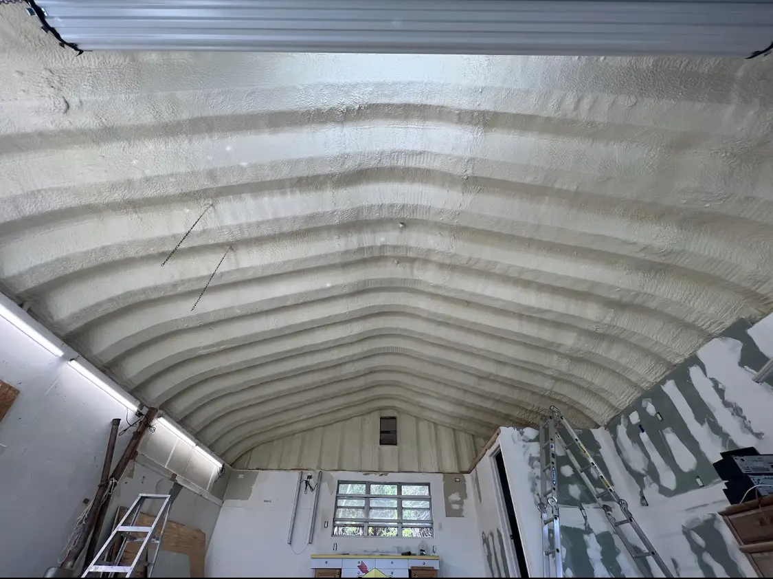 Spray polyurethane foam applied to the underside of a metal roof deck in Conway